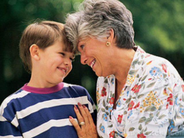 Woman and boy hugging outdoors