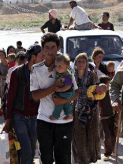 Displaced people from the minority Yazidi sect flee violence in the Iraqi town of Sinjar