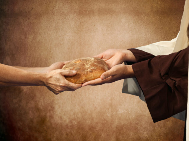 Jesus gives the bread to a beggar.